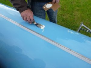 Kieran Hynse of Carrick Rowing Club working his magic on our damaged rowing shell.