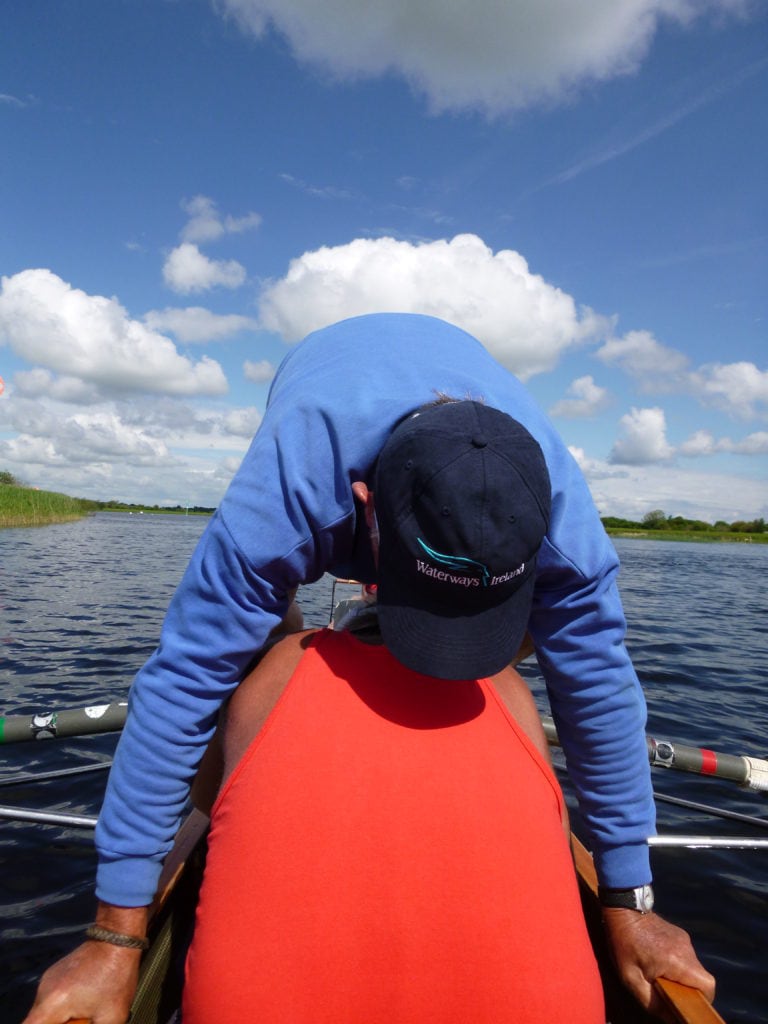 Switching seats on the water.  Good thing that rowers are fit and flexible, and that touring coxed quads are stable boats!