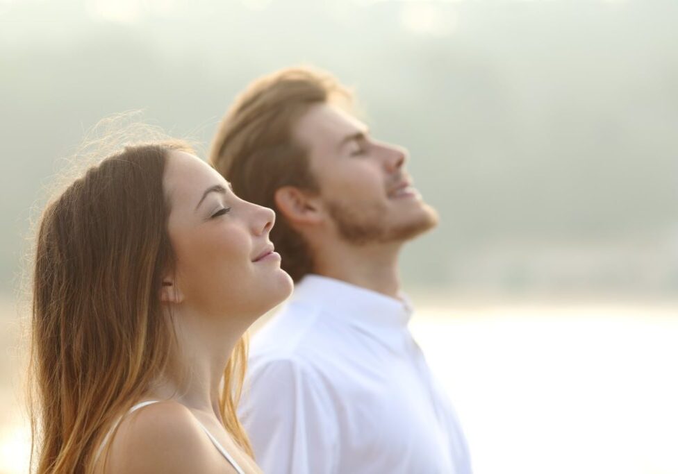 Couple of man and woman breathing deep fresh air
